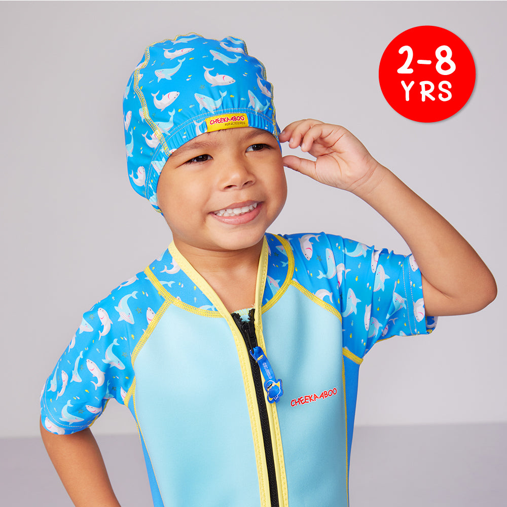 A kid wearing the Protective Toddler Spandex Swim Cap Shark