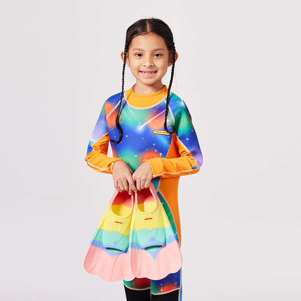 A kid holding the Cheekaaboo's Swim Fins in Pink Rainbow