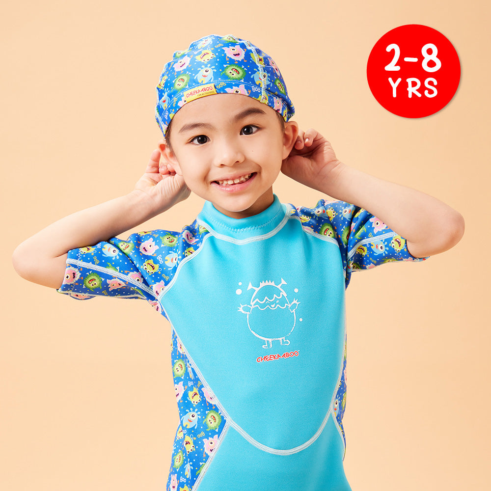A kid in Protective Toddler Swim Cap Blue Monster