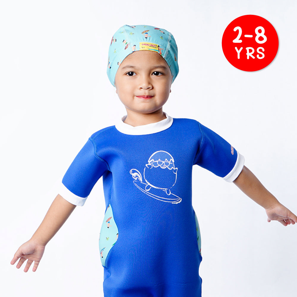 A kid wearing Cheekaaboo's Protective and Breathable Toddler Swim Cap Navy Blue Surfer