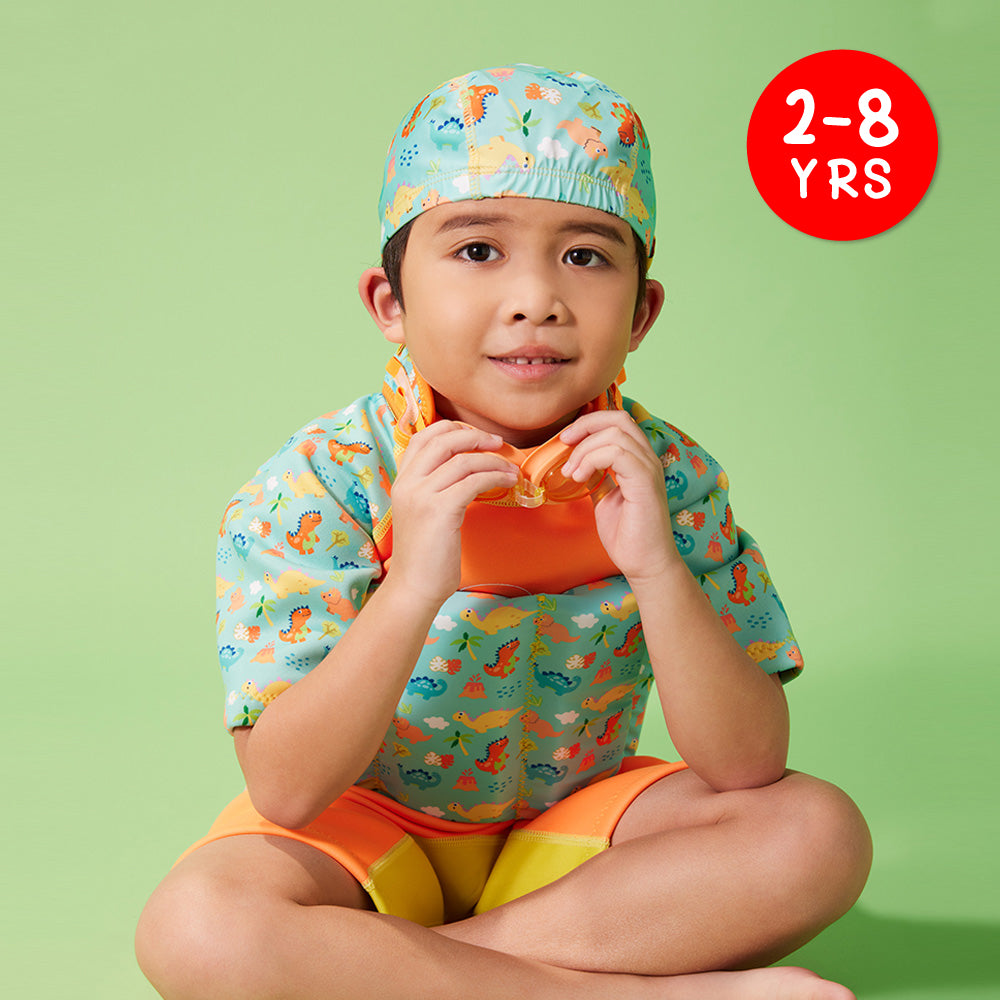 A kid wearing Soft Protective Toddler Swim Cap with Matching Orange Dino Thermal Swimsuit