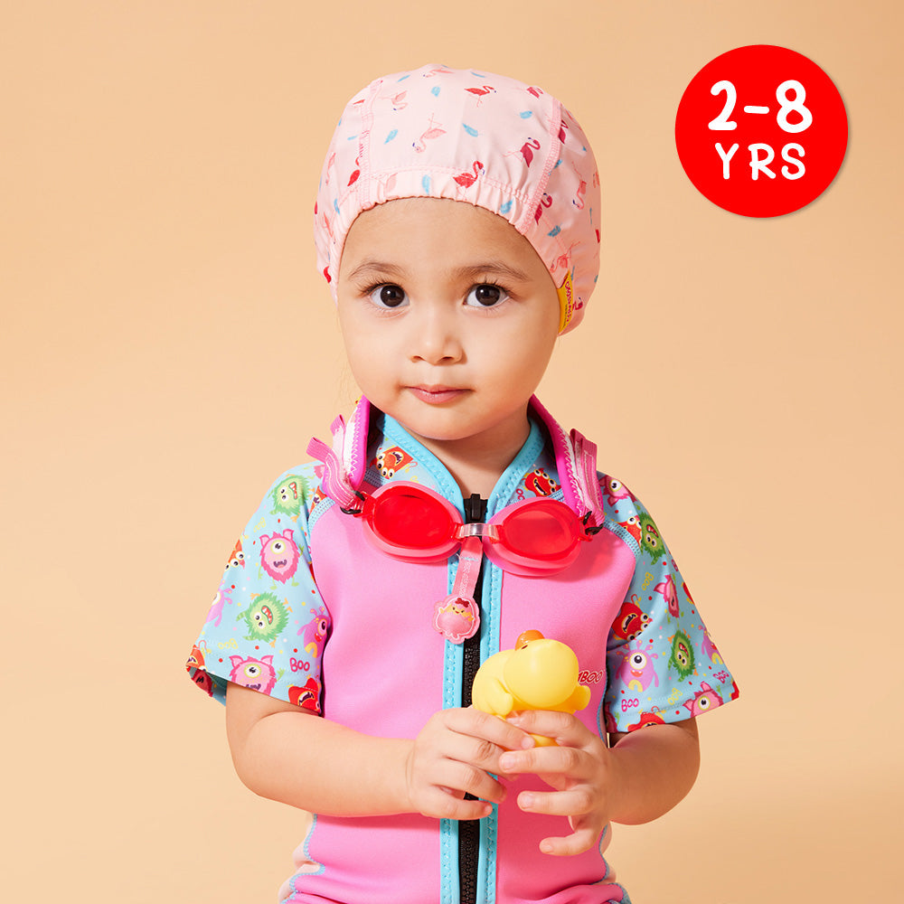 A kid wearing Protective Toddler Swim Cap Pink Flamingo