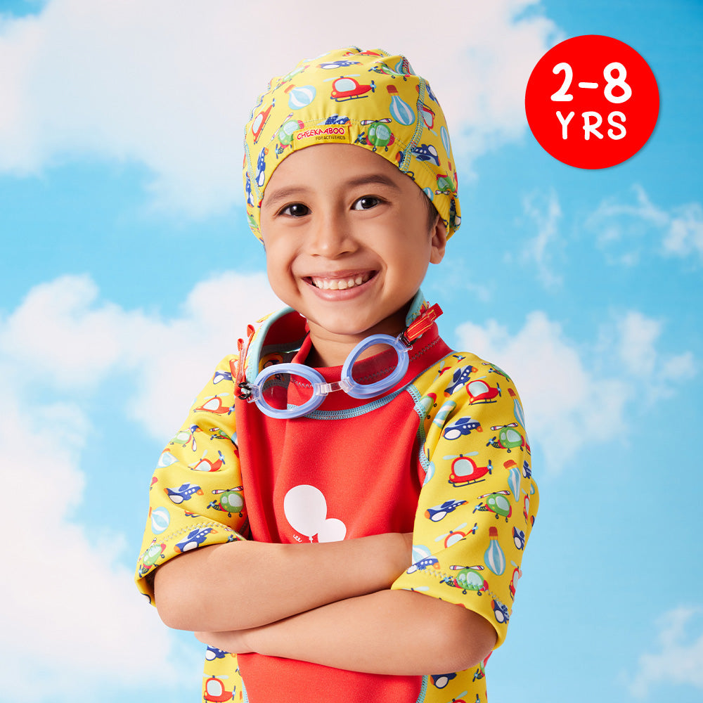 A kid wearing the Protective Toddler Bathing Cap Sky Transportation